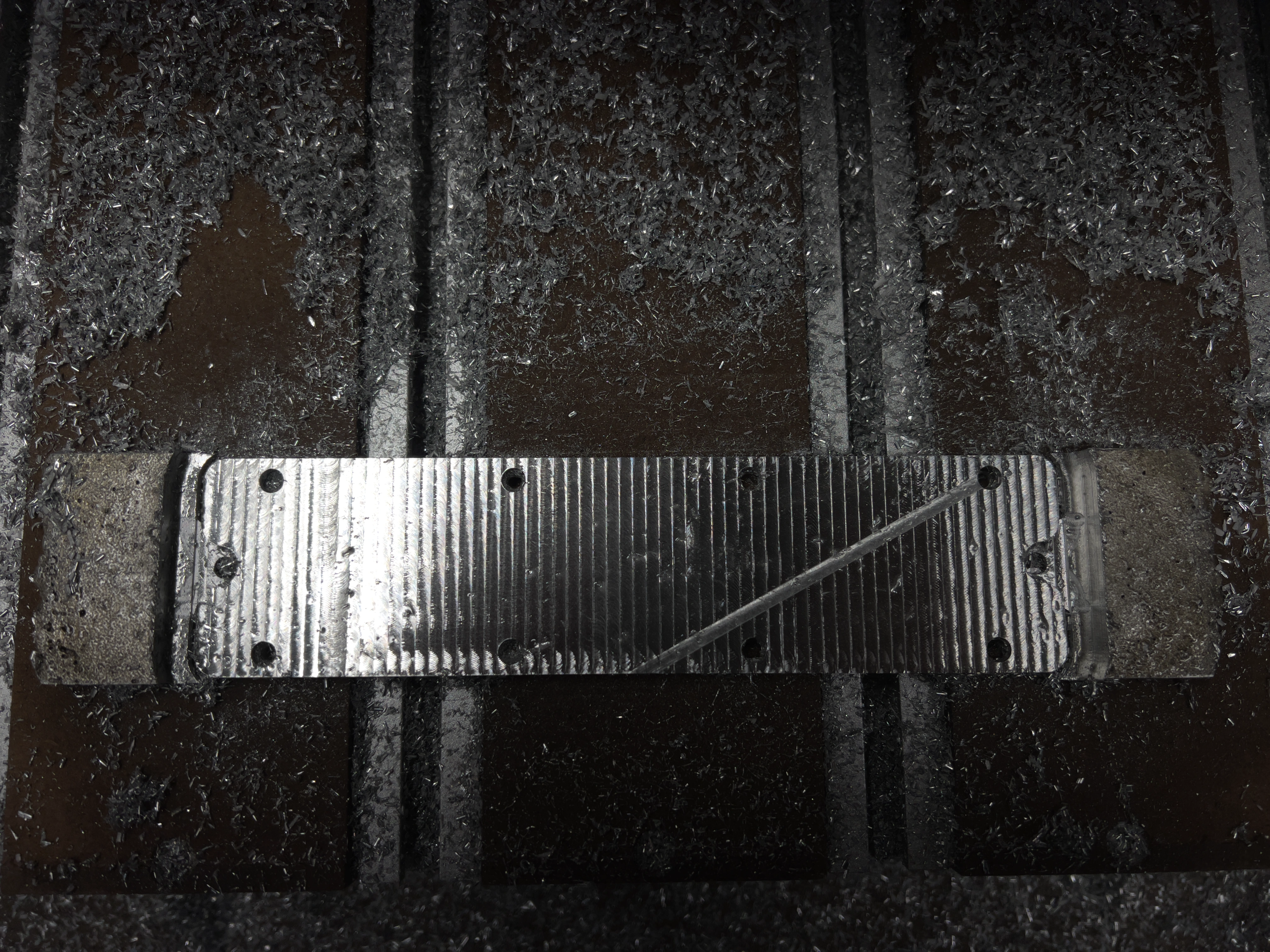 Battery holder plate milled top face