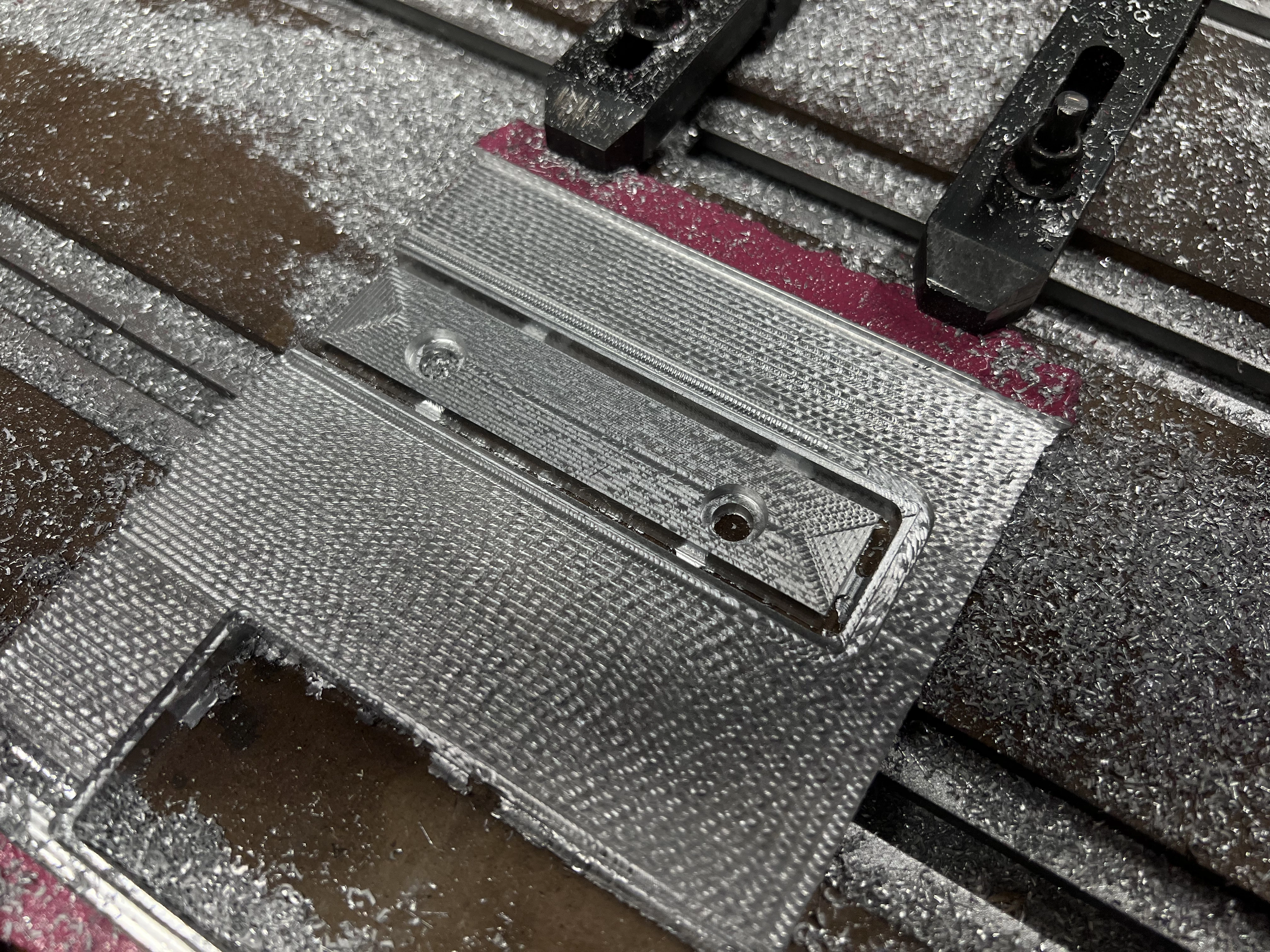 Part outline cut with tabs using hold-down clamps